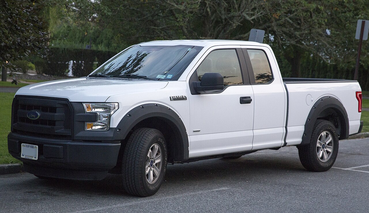 A white 2015 Ford F-150 XL pickup seen from the front left