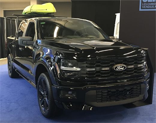 A black 2026 Ford F-150 Crew Cab displayed at the Montreal International Auto Show.